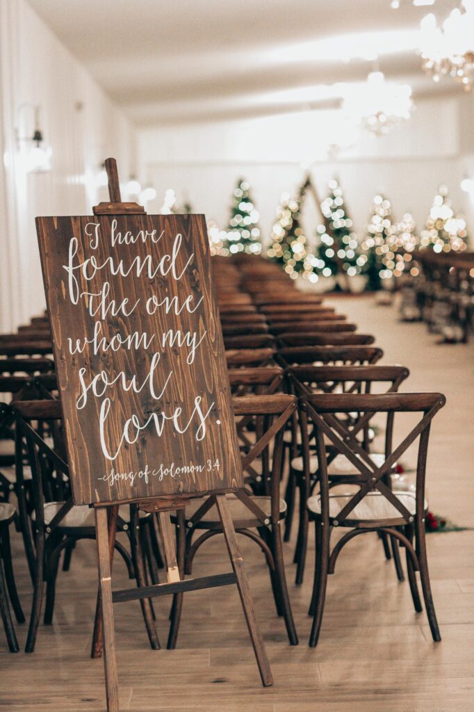 bible verse setup as decoration during inside wedding ceremony at The Grand Ol' Barn